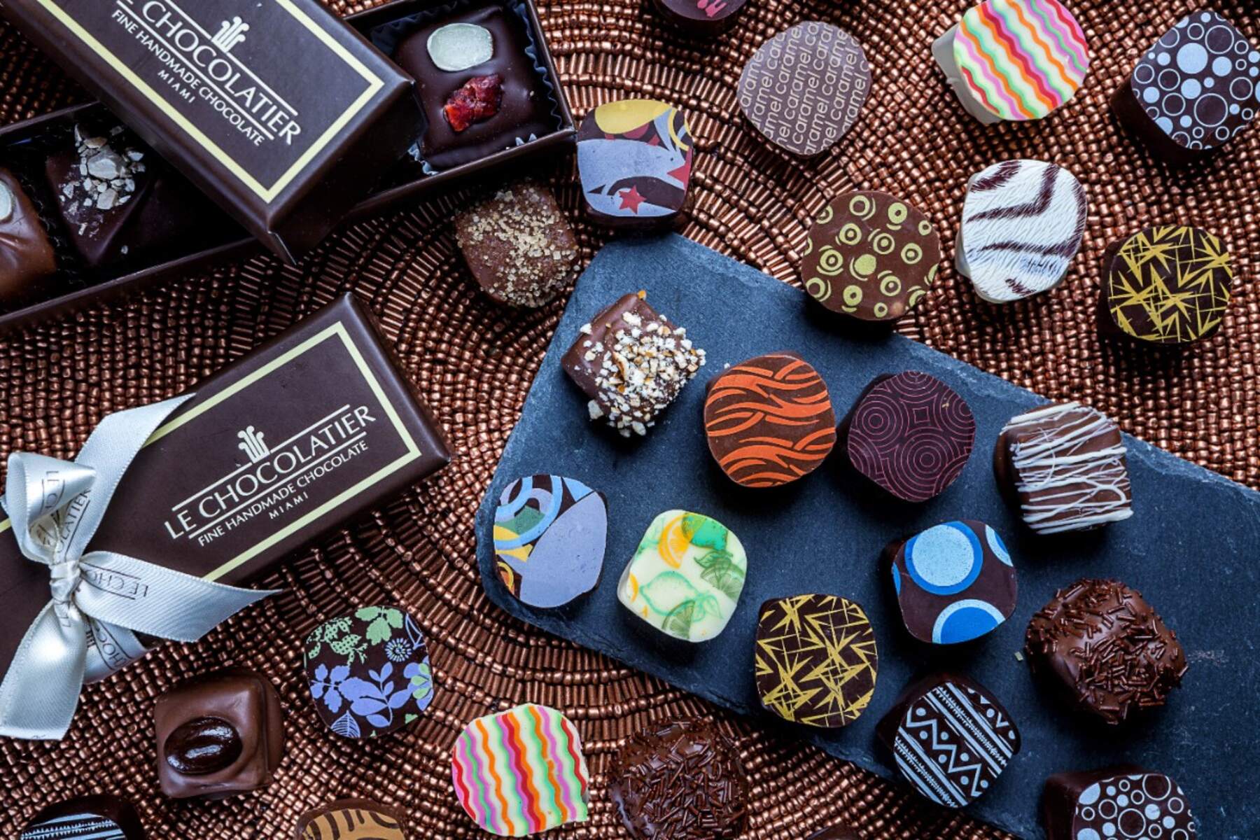 Assortment of chocolates on a table with a le chocolatier fine handmade chocolate