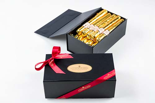 A handsome, black self-closing box of 10 chocolate cigars, each are 1 ounce of solid milk chocolate.